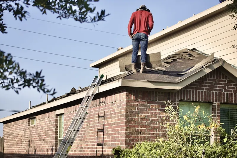 Professional roofer working on a residential roof in Midtown Elizabeth